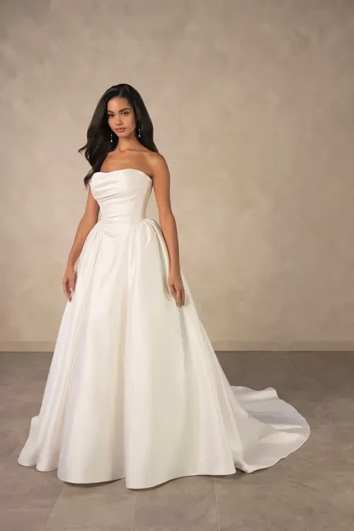 model is wearing a strapless a-line plus size wedding dress