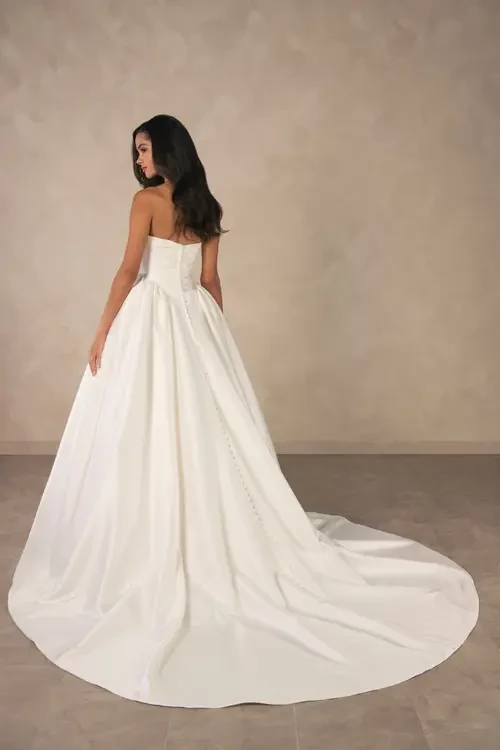 model is wearing a strapless a-line plus size wedding dress