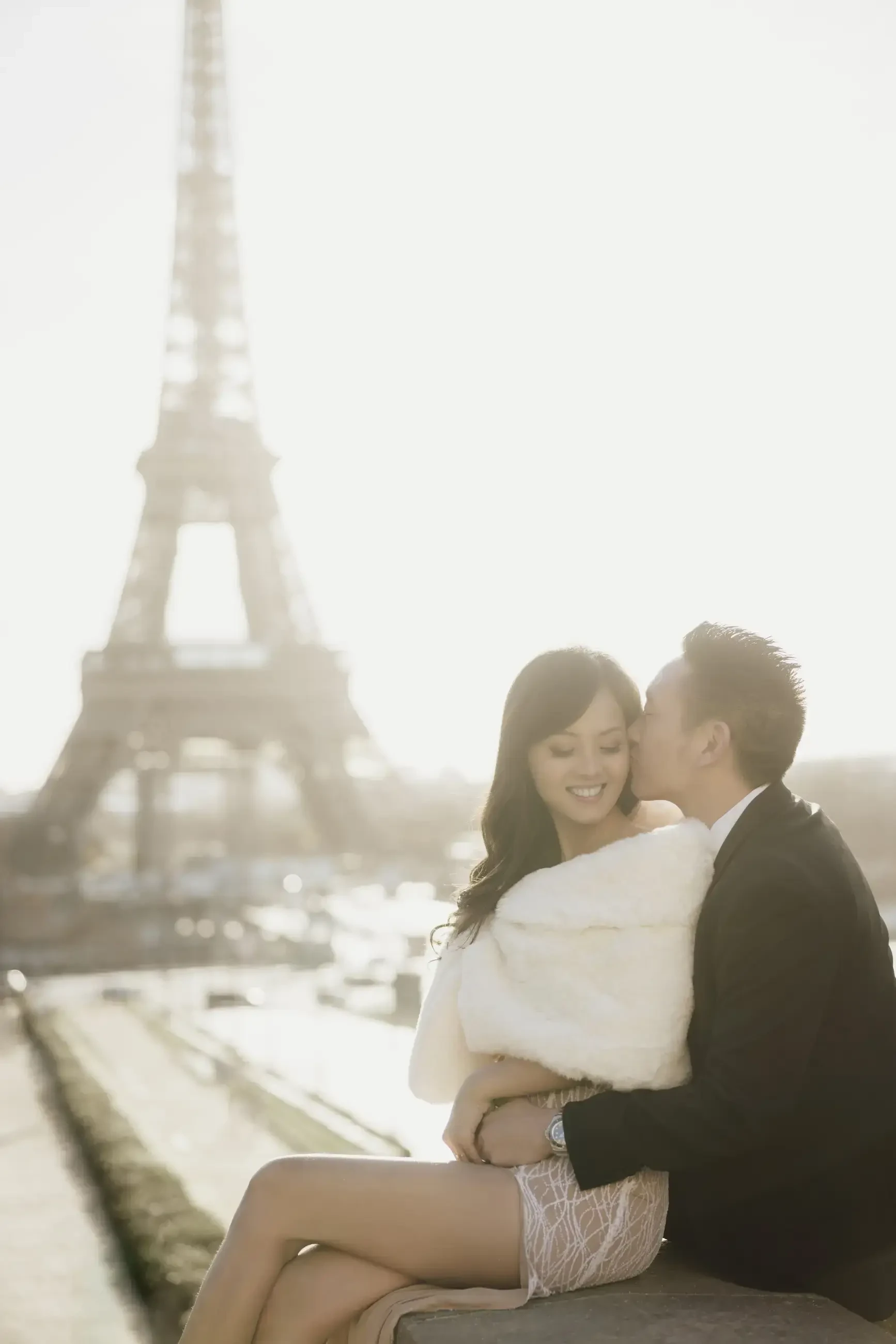 image shows a woman and man hugging each other in their wedding photo