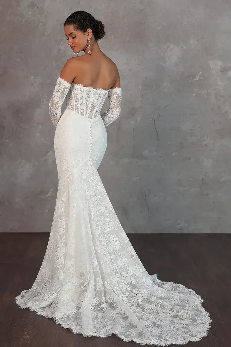 model is wearing a lace strapless fit and flare wedding dress with detachable long sleeves